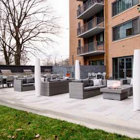 Barbecue with grey couches and green lawn around at The Graham at Southern Towers, Virginia, 22311