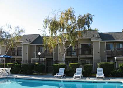 A swimming pool in front of apartment buildings.