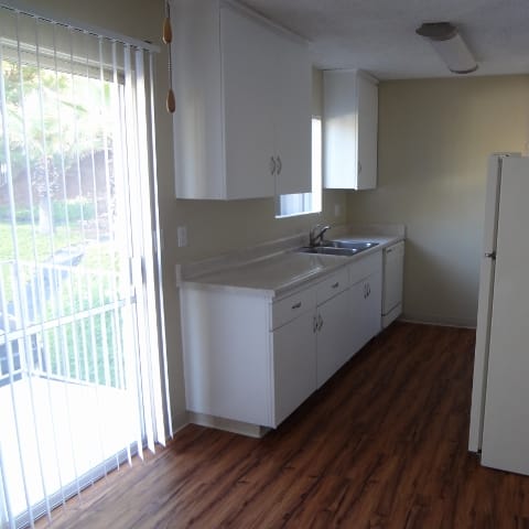 a kitchen with a sink and a refrigerator
