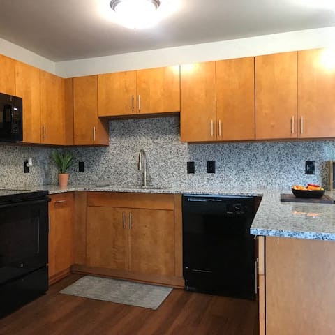 a kitchen with black appliances and wooden cabinets