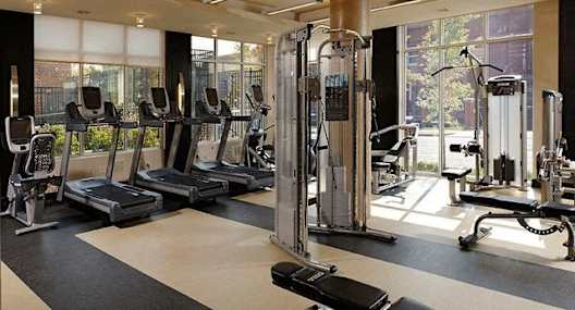 A gym with treadmills, weights, and exercise machines.