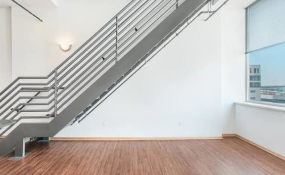 an empty room with a staircase and a window  at Boston Lofts, Milwaukee, 53203