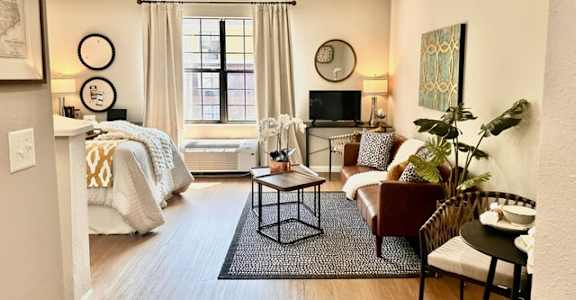 A living room with a couch, chair, and coffee table.
