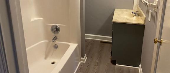 a bathroom with a bathtub and a sink