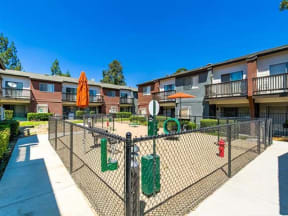 Pet-Friendly Apartments in Ontario CA - Encore - Fenced-In Dog Park with Green Activities and Bench