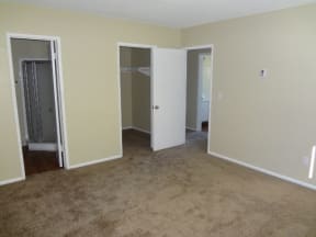 Large bedroom with spacious walk-in closet at Villa Knolls Apartments in La Mesa, California.