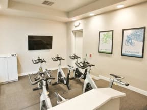 The Highland Apartments Fitness Studio with spin bikes and tv with fitness on demand classes