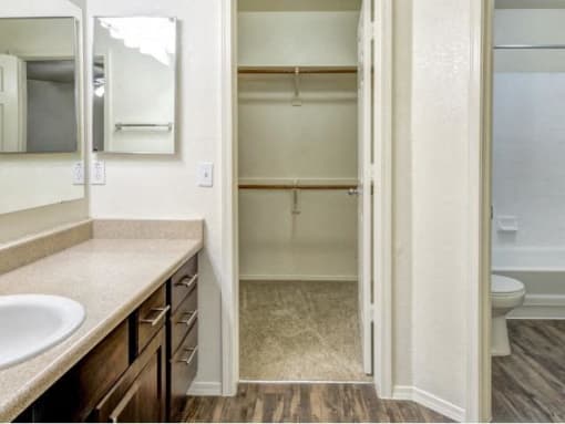 Ingleside Apartments Bathroom  with brown cabinets, beige counter tops and large walk in closet