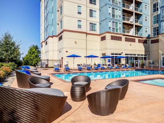 A large building with a pool in front of it.
