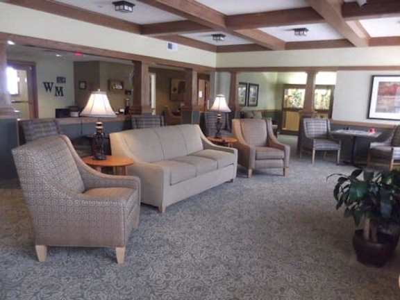 A living room with a couch, chair, and table.