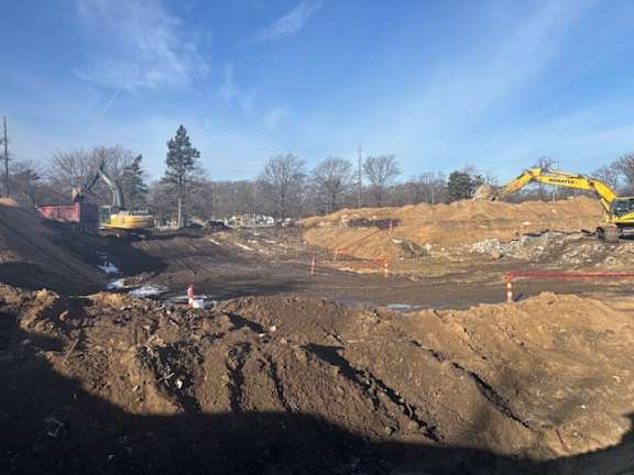 A construction site with an excavator and a bulldozer.