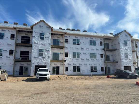 A building under construction with Tyvek branding on the siding.