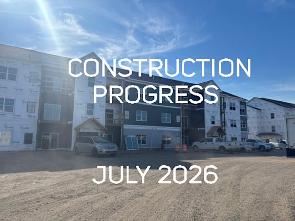 A construction site with the text "CONSTRUCTION PROGRESS JULY 2026" overlaid on the image.