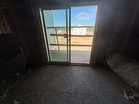 A view from inside a room looking out through a sliding glass door.