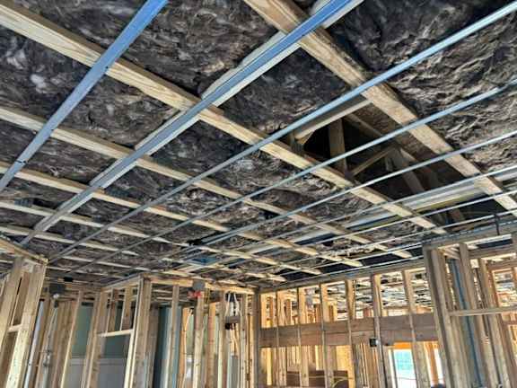 A wooden frame structure of a building under construction.