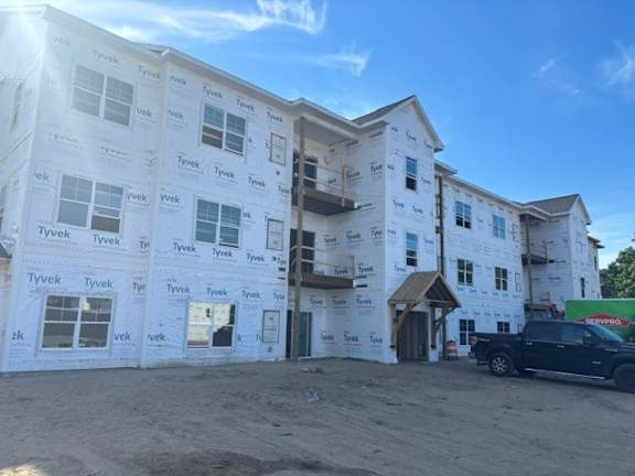 A building under construction with Tyvek branded insulation on the exterior walls.