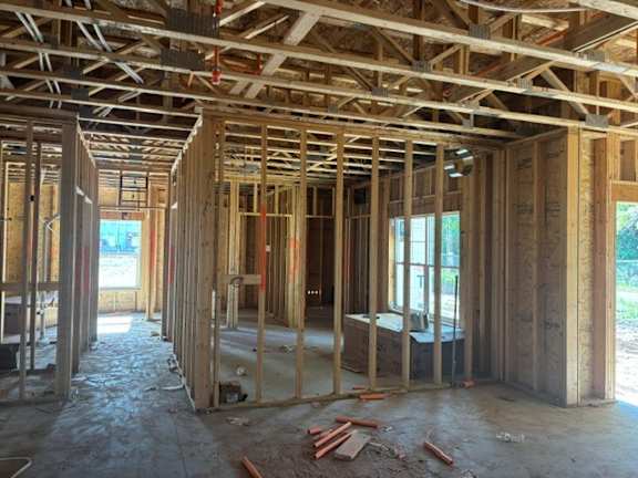 A house under construction with wooden beams and no walls.