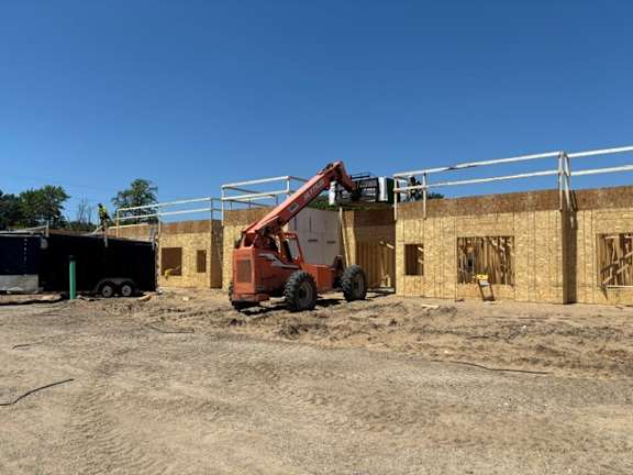 A construction site with a crane and a building under construction.