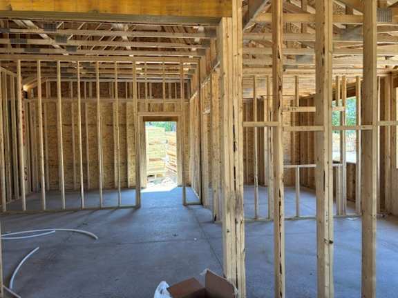 A room under construction with wooden beams and no walls.
