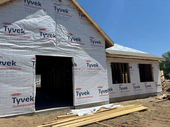 A house under construction with Tyvek Commercial Wrap insulation.