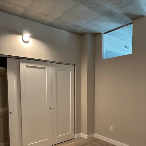 A white cabinet with a skylight above it.