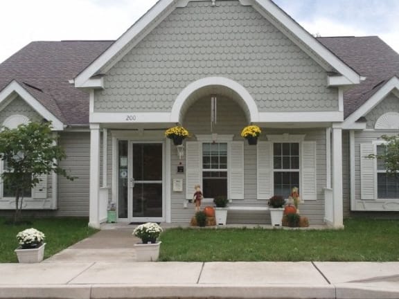 a white house with a front porch and a sidewalk