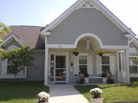 the front of a house with a porch and a walkway
