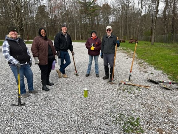a group of people standing on a gravel road