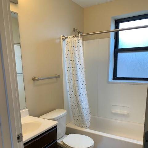 a bathroom with a shower and a toilet and a sink