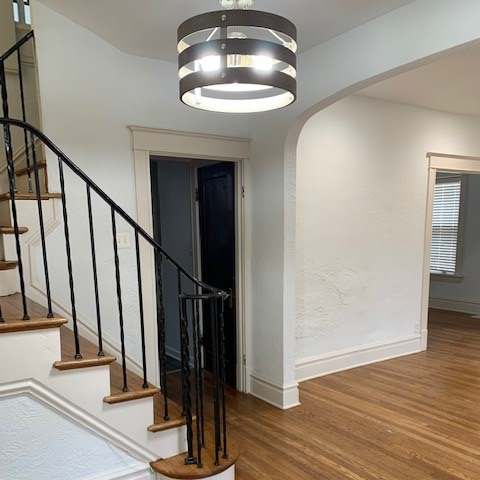 a stairwell with a railing and a window on top of it