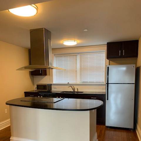 a kitchen with a refrigerator and a mirror