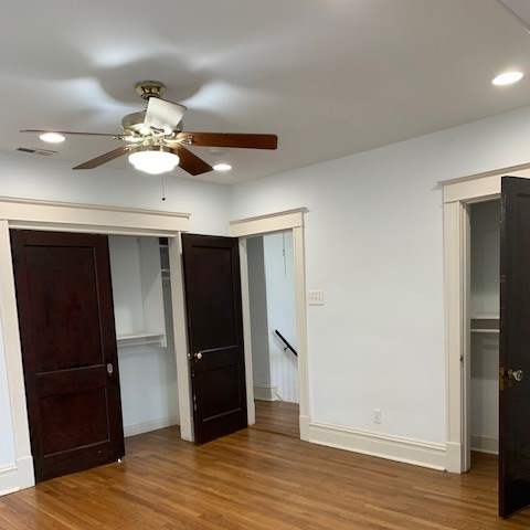 a small room with a refrigerator and a closet