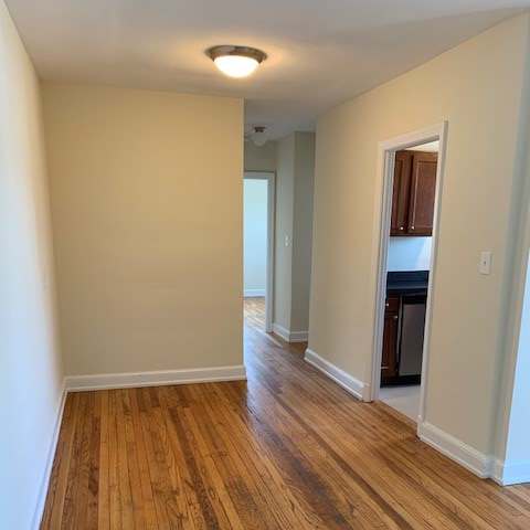 a hallway with a wood accent wall and a white floor