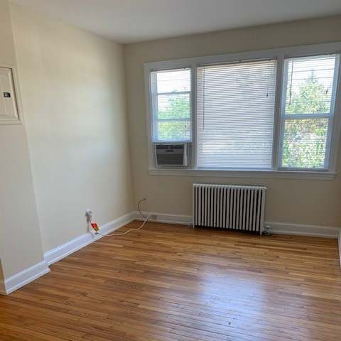 an empty room with a window and a wooden wall