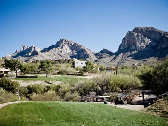 a golf course with the superstitious mountains in the background