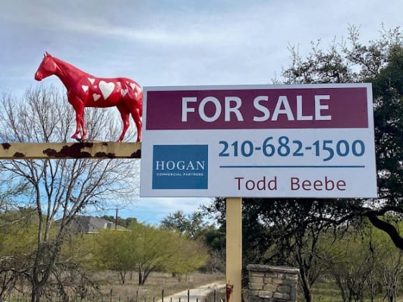 a for sale sign with a horse on top of it