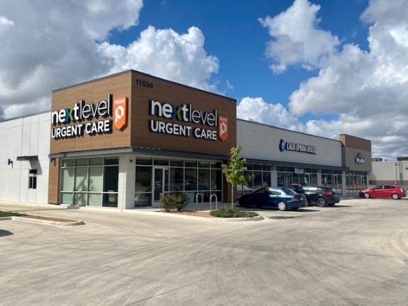 a new ne fleet urgent care building with cars parked in front of it