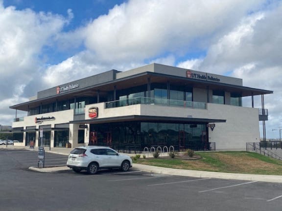 a new ne fleet urgent care building with cars parked in front of it