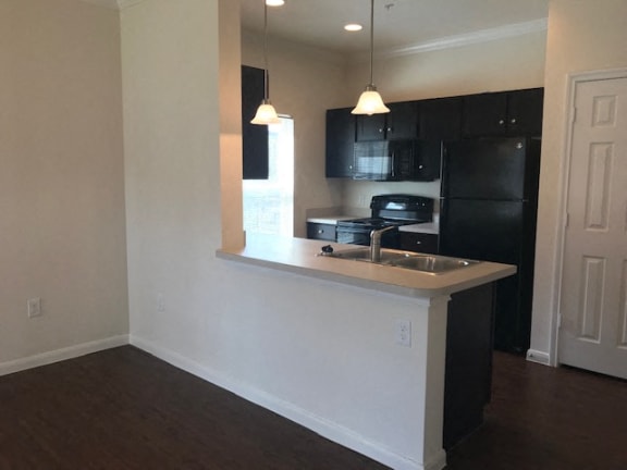 Updated Kitchen With Black Appliances at CLEAR Property Management , The Lookout at Comanche Hill, San Antonio, 78247