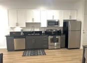 Thumbnail 2 of 13 - a kitchen with stainless steel appliances and white cabinets