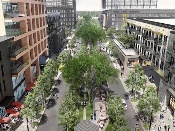 A tree-lined street with people walking on the sidewalks.