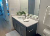 Thumbnail 12 of 13 - a bathroom with a sink and a mirror