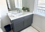 Thumbnail 13 of 13 - a bathroom with a sink and a mirror