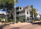 Thumbnail 3 of 24 - Ingleside apartment building with beige and grey paint and gated entrance