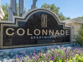 Colonnade Apartments' monument sign with floral surrounding landscape