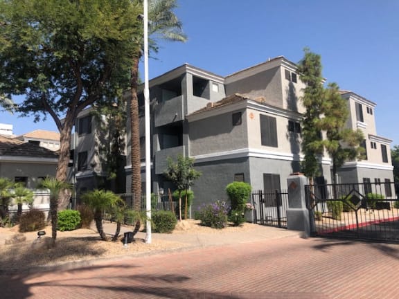 Ingleside apartment building with beige and grey paint and gated entrance