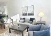 Thumbnail 11 of 13 - a living room with a couch and a table