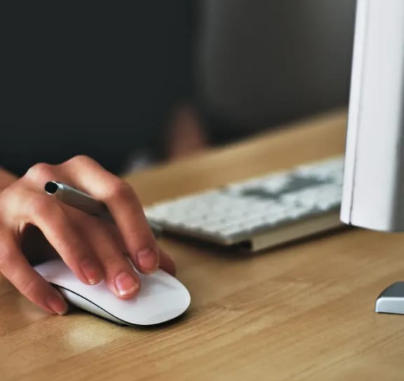 a person using a computer mouse and keyboard