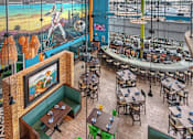 Thumbnail 2 of 8 - A restaurant with a large mural of a man on a beach.