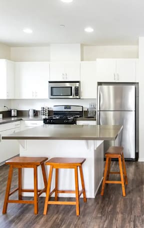 a kitchen and dining area with a table and chairs
